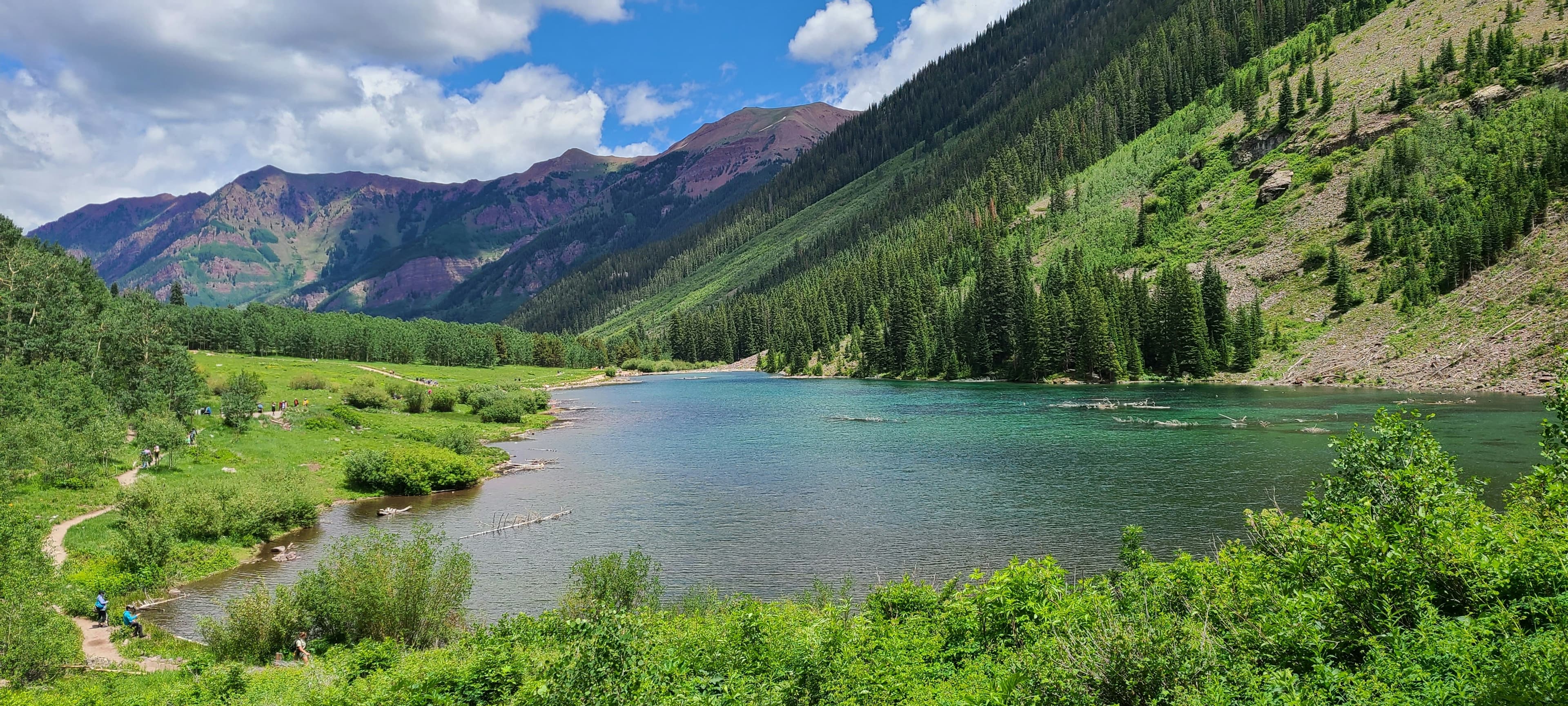 A mountain valley surrounding a blue lake.